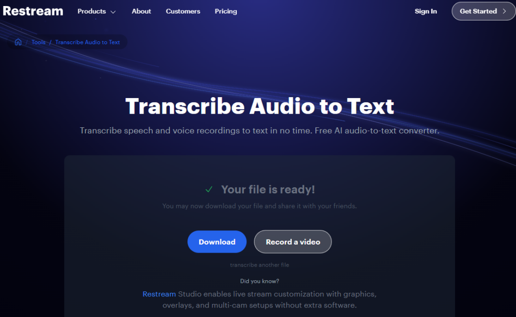 The Restream "Transcribe Audio to Text" page, described as a free AI audio-to-text converter, showing the message "Your file is ready!" with Download and Record a video buttons.